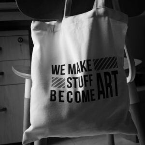 A white tote bag sitting on top of a chair
