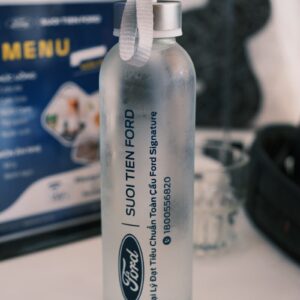 Ford water bottle sits near a menu.
