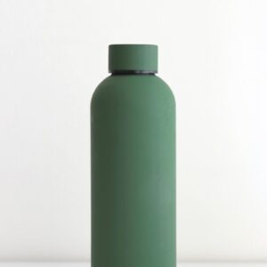 green bottle on white table